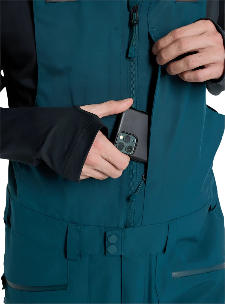 Burton Reserve Bib Pant 2025 - Dark blue bib pant with black trim, featuring a zippered fly and adjustable waist belt.