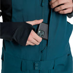 Burton Reserve Bib Pant 2025 - Dark blue bib pant with black trim, featuring a zippered fly and adjustable waist belt.