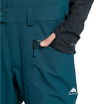 Burton Reserve Bib Pant 2025 - Dark-colored bib pant with a white logo on the left leg and black zippers.