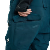 Burton Reserve Bib Pant 2025 - Dark-colored bib pant with a white logo on the left leg featuring a mountain peak design and the word "BURTON" in small letters underneath.