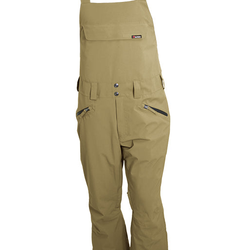 Turbine Mission II Bib - A pair of khaki-colored bib overalls with black straps and a small logo on the chest pocket.