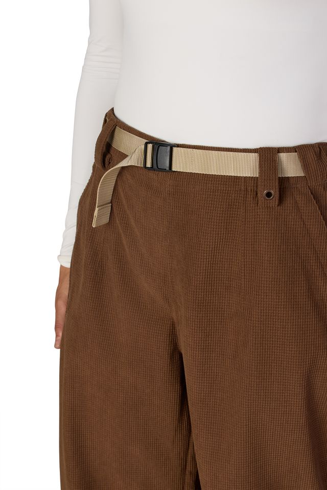 Brown pants with adjustable belt strap and button closure at waist