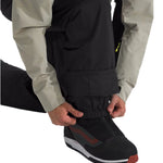 North Face Men's Freedom Insulated Pant - A pair of black insulated pants with a zippered pocket on the side.