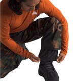 North Face Freedom Shell Pant - A pair of black pants with a subtle green pattern on the side, featuring a zippered pocket and adjustable cuffs.