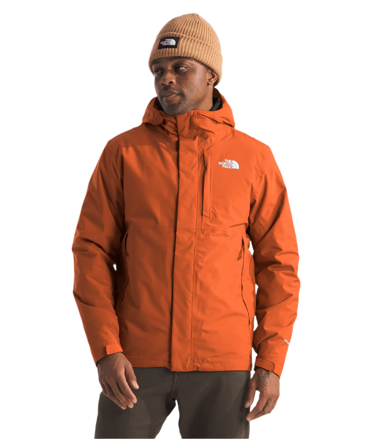 North Face Carto Triclimate Jacket - A man wearing a burnt orange jacket with a white logo on the left chest and two zippered pockets on either side of the waist.
