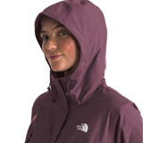 North Face Women's Antora Triclimate Jacket - A woman wearing a purple jacket with a hood, posing in front of a gray background.