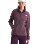 North Face Women's Antora Triclimate Jacket - A woman wearing a purple jacket with a white logo on the left chest, standing against a light gray background.