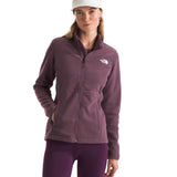 North Face Women's Antora Triclimate Jacket - A woman wearing a purple jacket with a white logo on the left chest, standing against a light gray background.