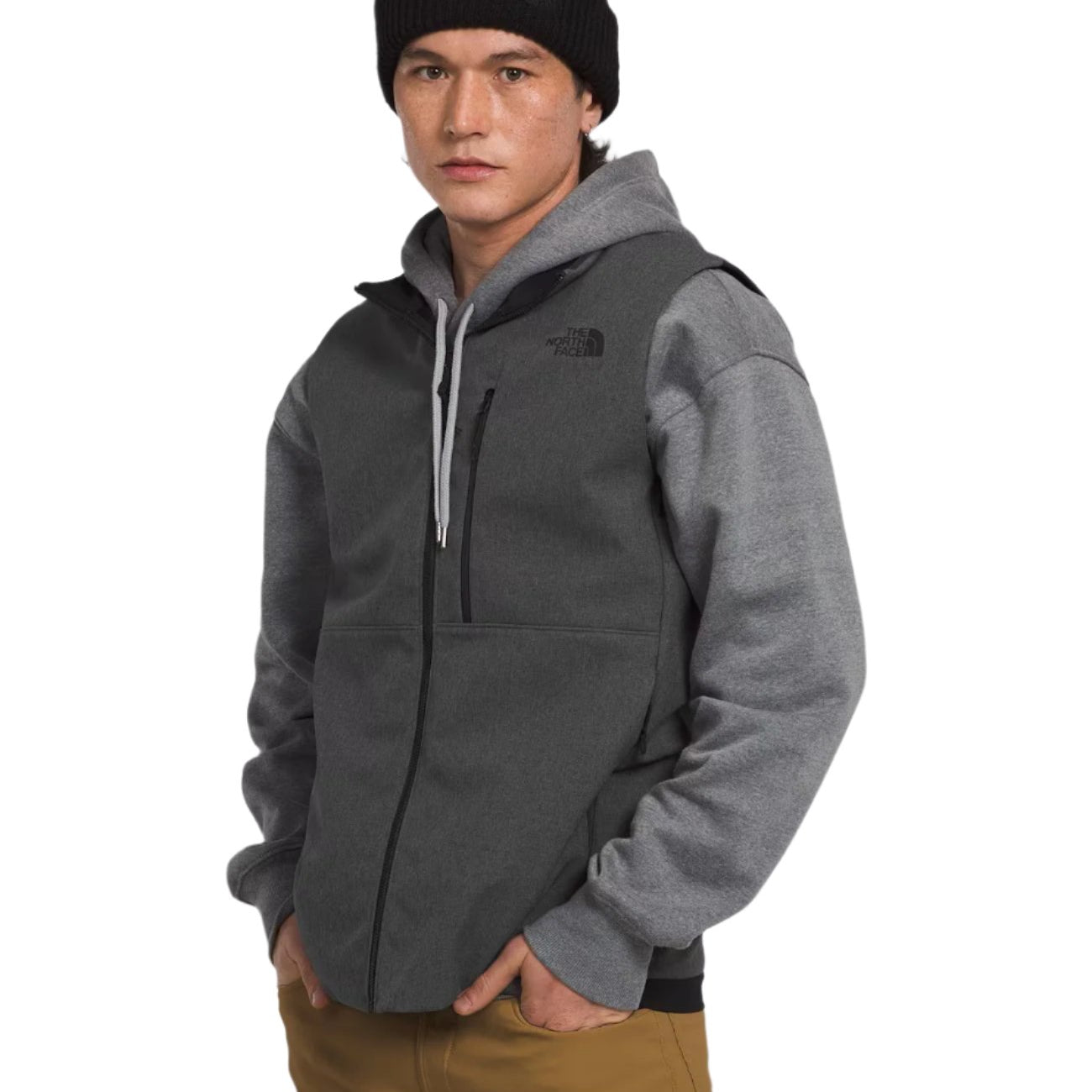 North Face Apex Bionic Vest - A dark gray vest with a zippered front and two side pockets, worn by a model over a light gray hoodie.