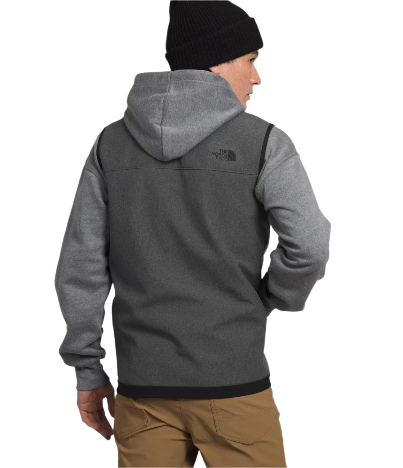 North Face Apex Bionic Vest - A man wearing a gray hooded sweatshirt with a black logo on the upper left chest area, paired with khaki pants and a black beanie.