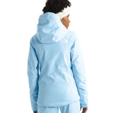 North Face Women's Lenado Insulated Jacket - A woman wearing a light blue jacket with a white logo on the back, standing in front of a plain background.