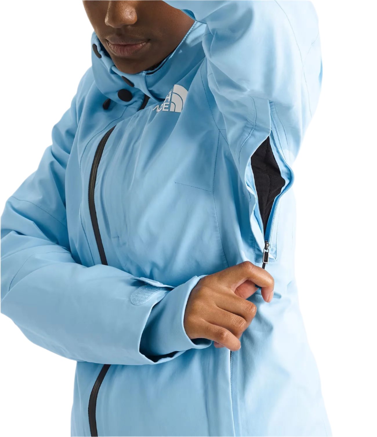 North Face Women's Lenado Insulated Jacket - A woman wearing a light blue jacket with black zippers and buttons, featuring The North Face logo on the left chest area.
