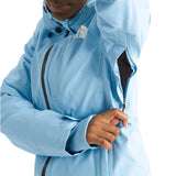 North Face Women's Lenado Insulated Jacket - A woman wearing a light blue jacket with black zippers and buttons, featuring The North Face logo on the left chest area.