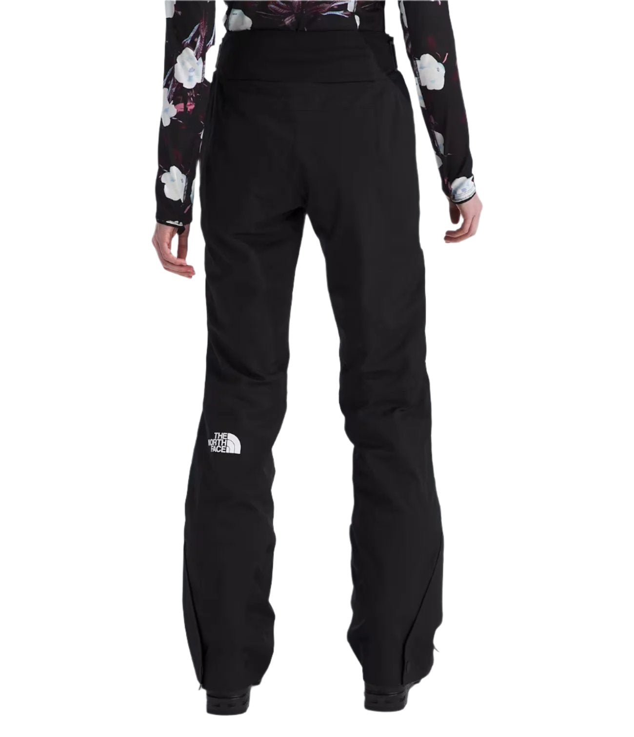 North Face Women's Lenado Insulated Pant - A pair of black insulated ski pants with a white logo on the left leg and a zippered pocket on the right thigh.