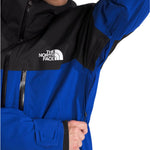 North Face Chakal Insulated Jacket - A black jacket with a white logo on the chest and a zipper down the front.