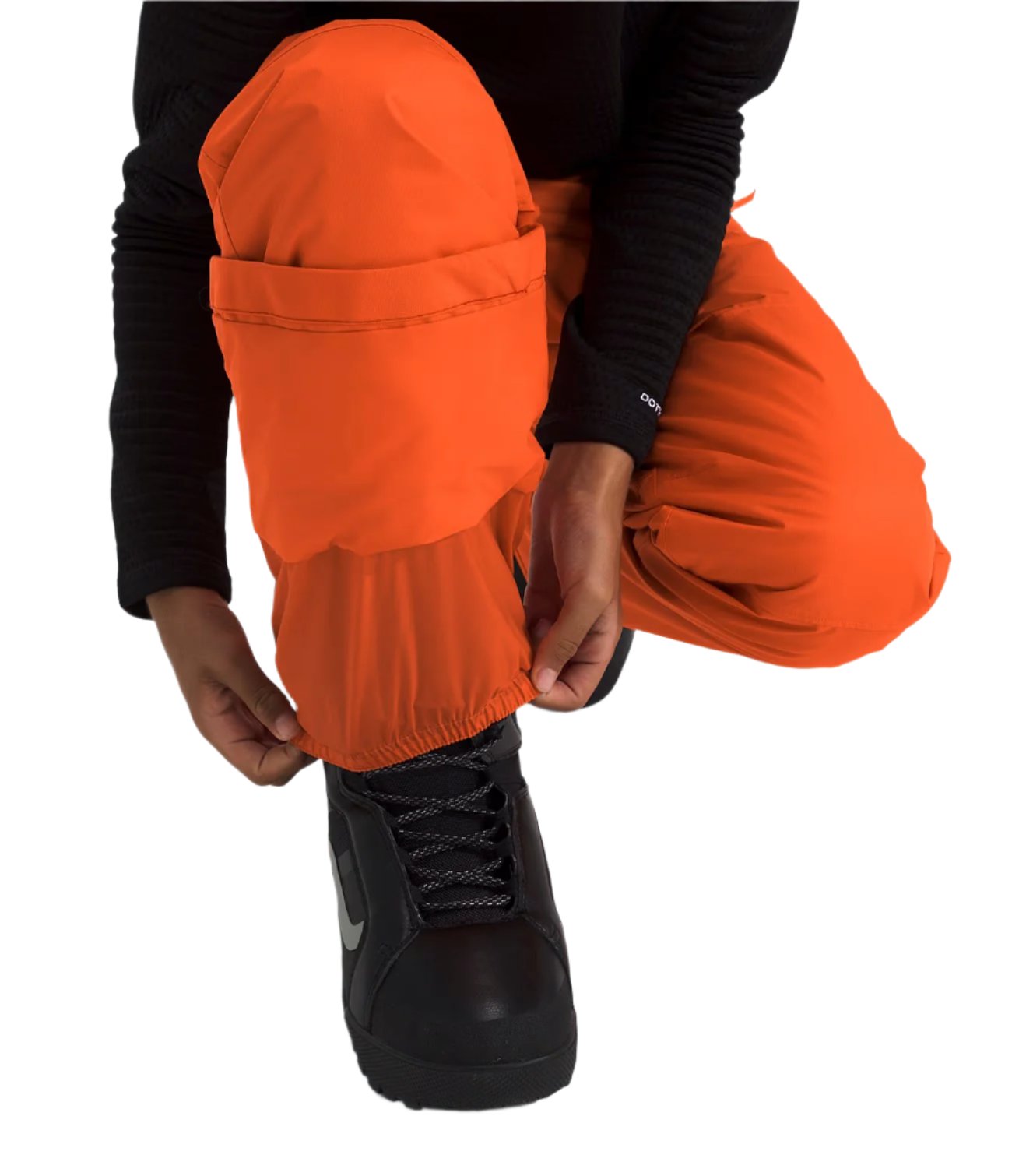 North Face Boys' Freedom Insulated Pant - A pair of orange snow pants with a black logo on the left leg, featuring a zippered pocket and adjustable cuffs.