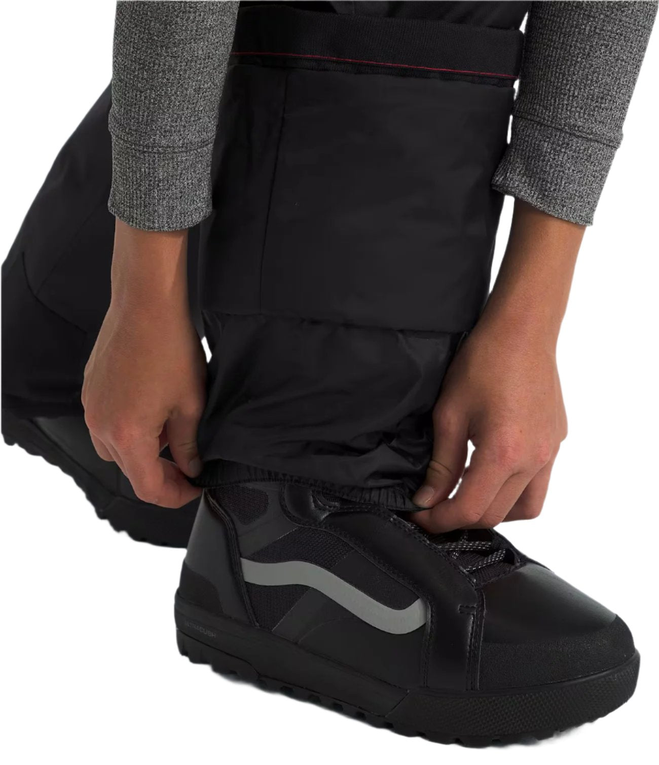 North Face Boys' Freedom Insulated Pant - A pair of black insulated pants with a red stripe on the waistband, worn by an adult model.