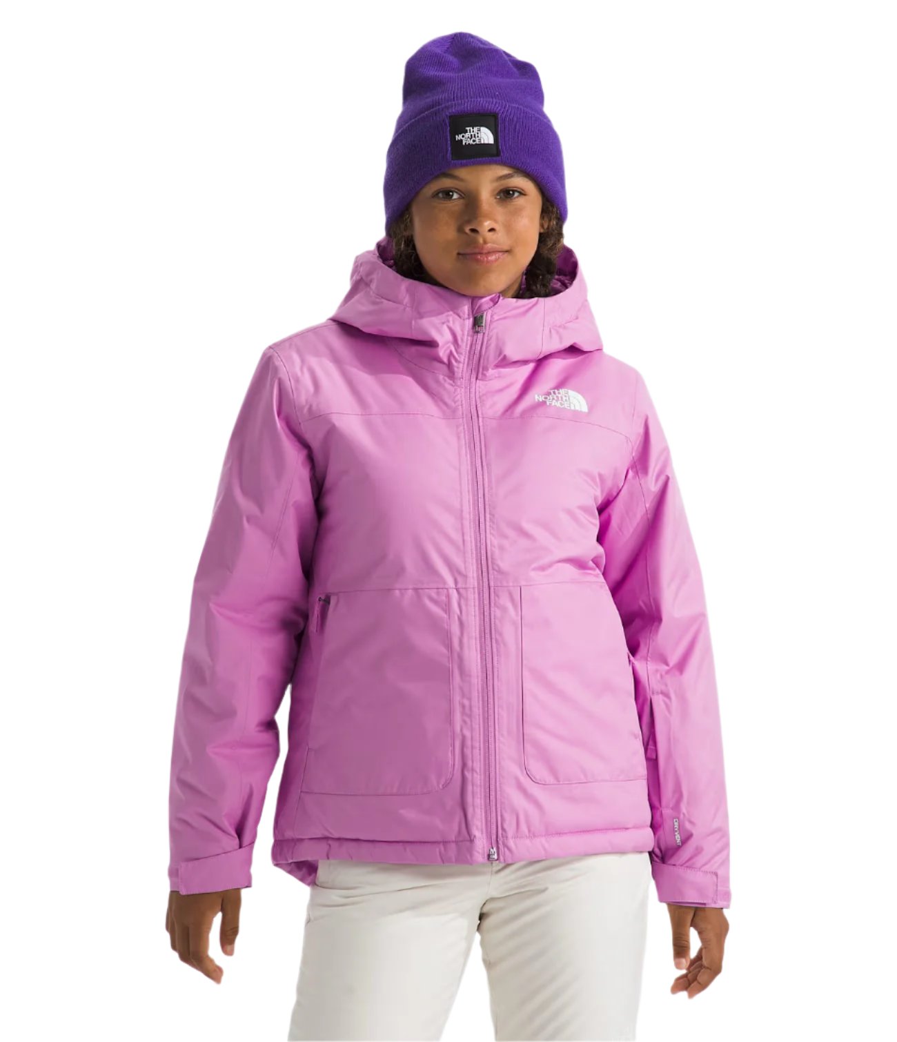 North Face Girls' Freedom Insulated Jacket - A young girl wearing a pink jacket with a white logo on the left chest and a hood, standing against a light gray background.