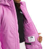 North Face Girls' Freedom Insulated Jacket - A young girl wearing a black top and white pants, showcasing the jacket's vibrant purple color with a subtle sheen.
