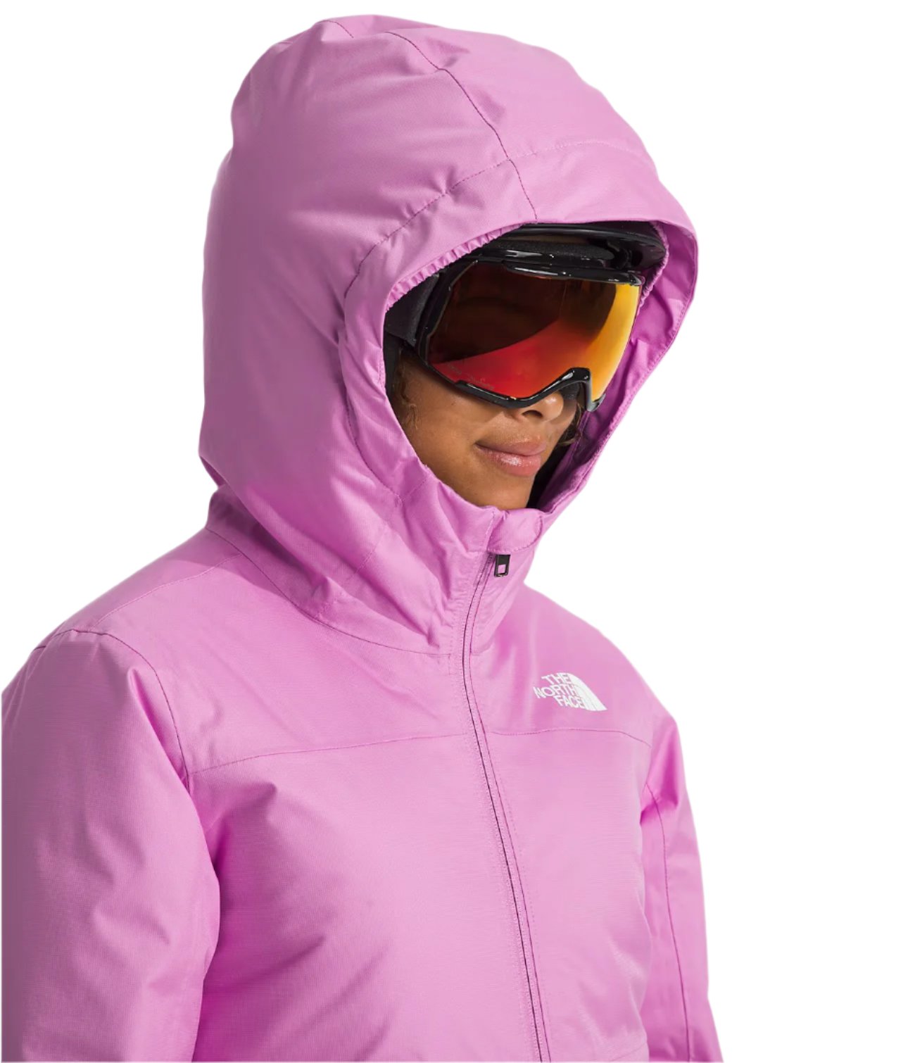 North Face Girls' Freedom Insulated Jacket - A young girl wearing a pink jacket with a white logo on the left chest, looking down at something out of frame.