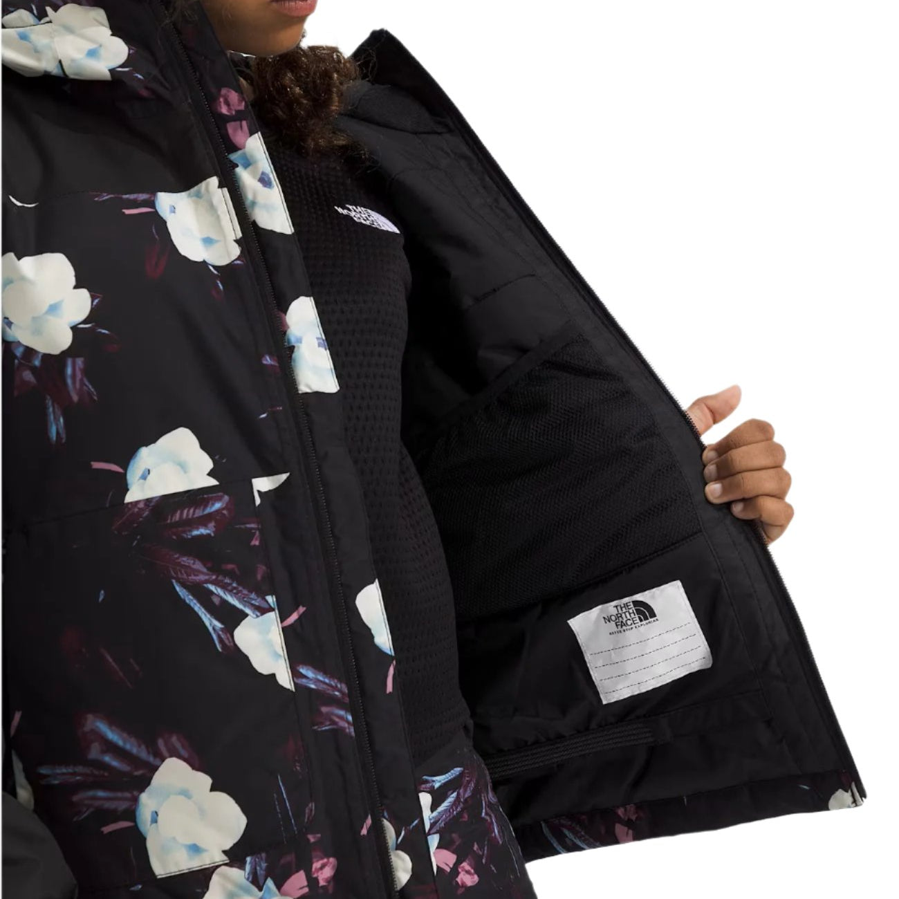 North Face Girls' Freedom Insulated Jacket - A black jacket with a white logo on the left chest and a floral pattern of white, blue, and purple flowers.