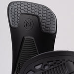 Nidecker Kaon Snowboard Binding 2025 - A black snowboard binding with a circular logo featuring an "N" and two parallel lines, positioned at the top center of the baseplate.