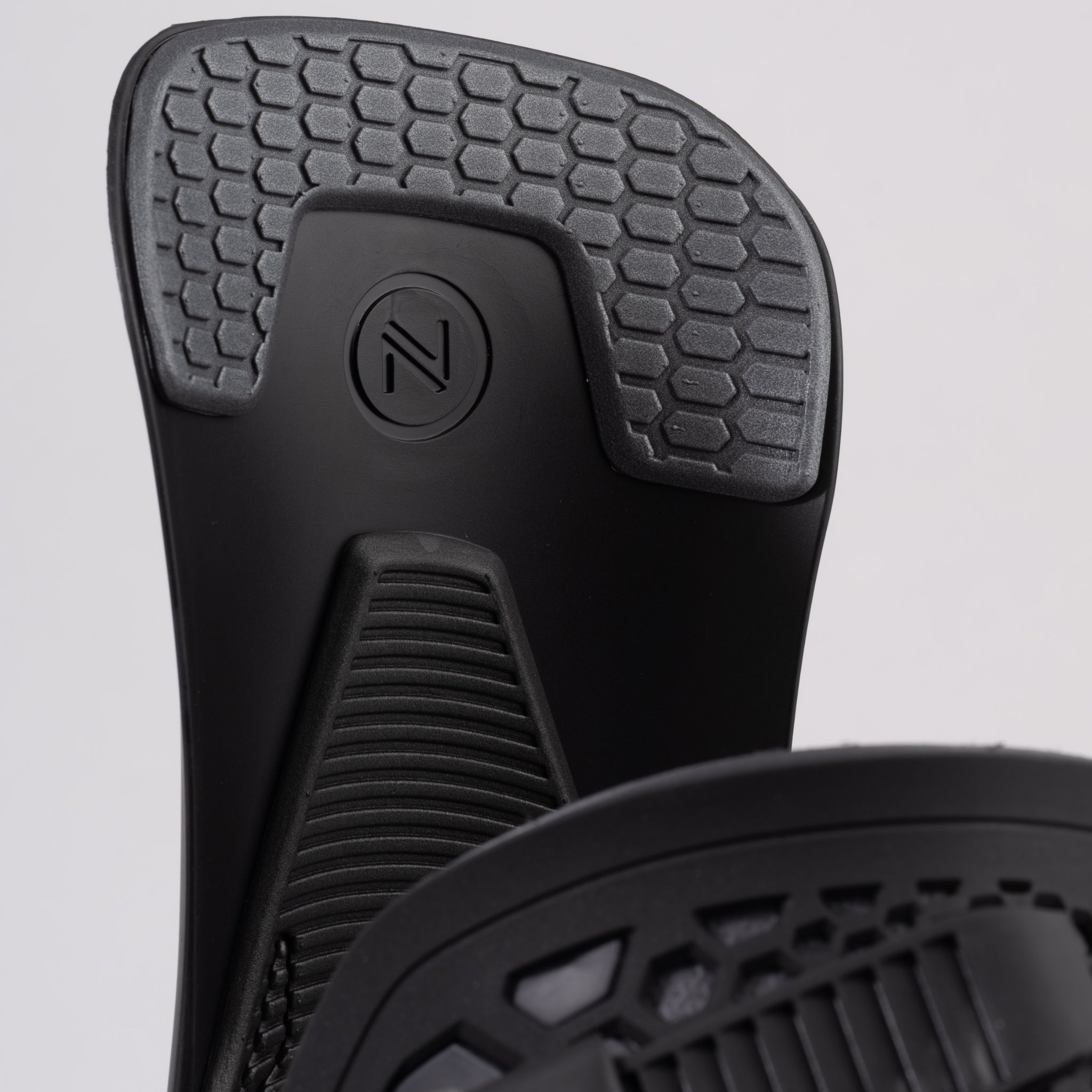 Nidecker Kaon Snowboard Binding 2025 - A black snowboard binding with a circular logo featuring an "N" and two parallel lines, positioned at the top center of the baseplate.