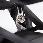 Nidecker Supermatic Carbon Snowboard Bindings 2025 - A pair of black snowboard bindings with silver buckles and screws, featuring a carbon fiber design on the baseplate.