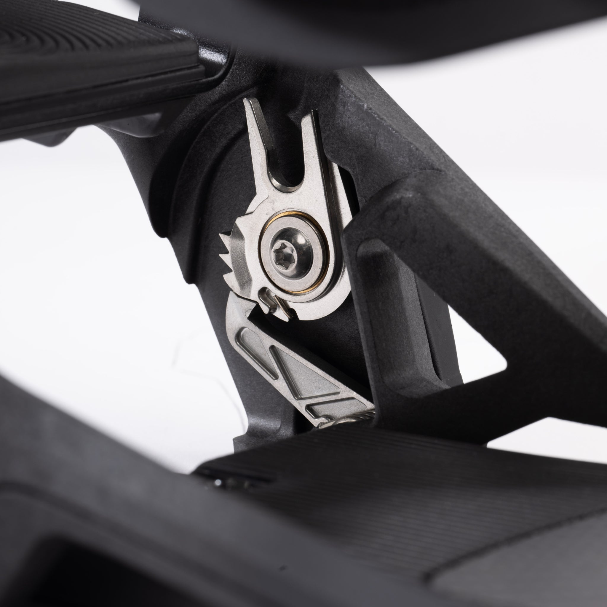 Nidecker Supermatic Carbon Snowboard Bindings 2025 - A pair of black snowboard bindings with silver buckles and screws, featuring a carbon fiber design on the baseplate.