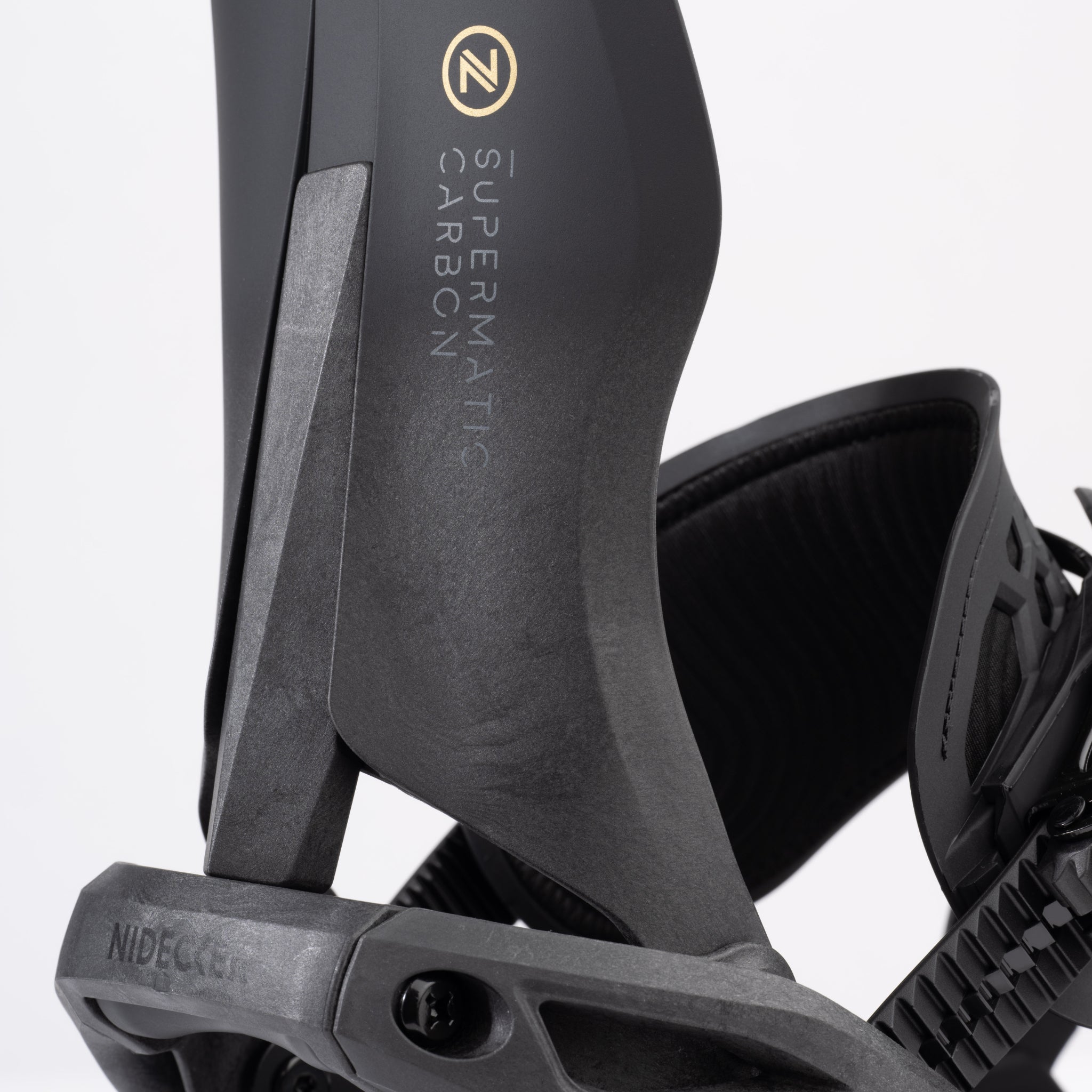 Nidecker Supermatic Carbon Snowboard Bindings 2025 - Black snowboard bindings with gold logo and white lettering on top strap.