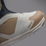 Nidecker Women's Cascade Snowboard Boot 2025 - A white snowboard boot with a tan stripe and laces, featuring a brown logo on the side.