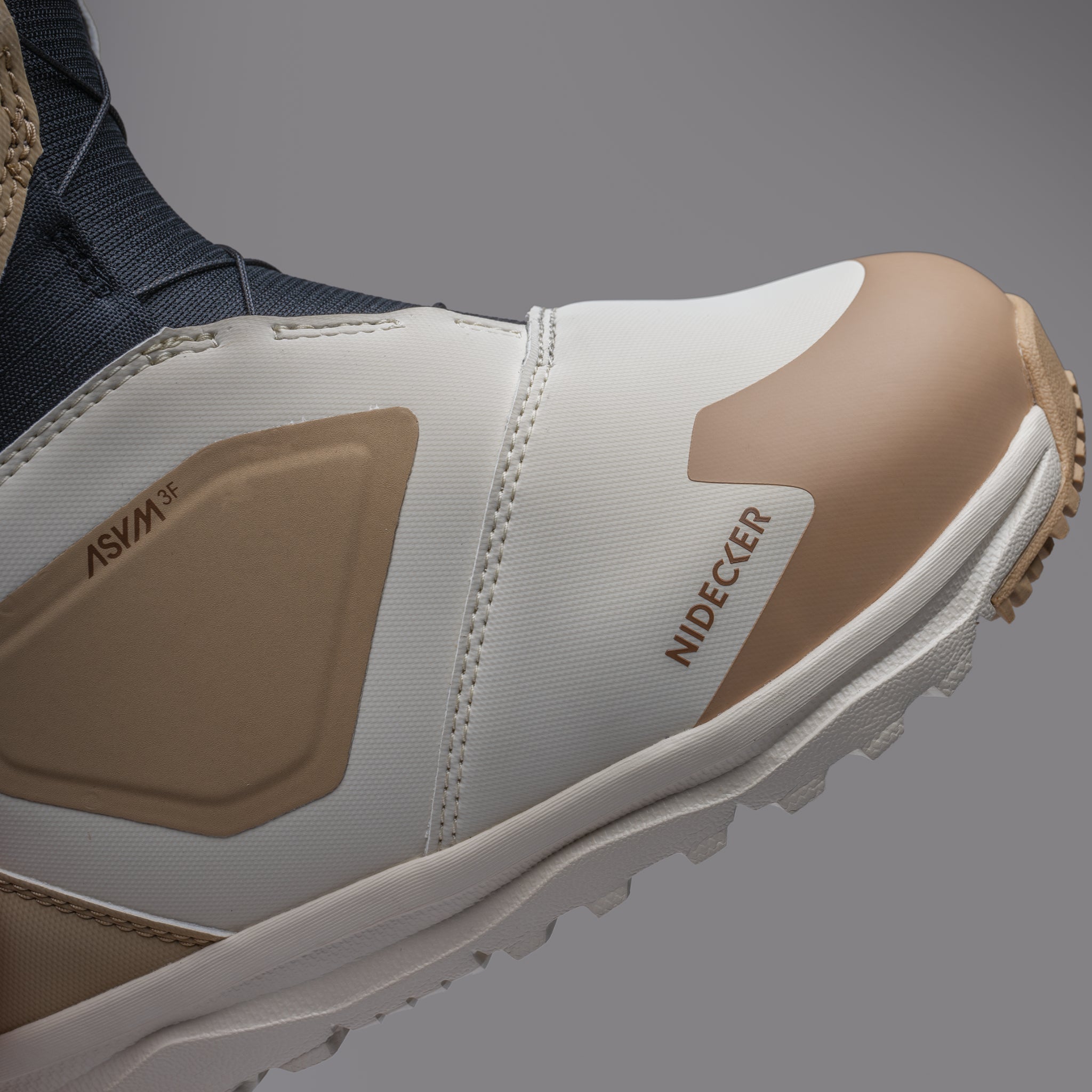 Nidecker Women's Cascade Snowboard Boot 2025 - A white snowboard boot with a tan stripe and laces, featuring a brown logo on the side.