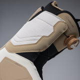 Nidecker Women's Cascade Snowboard Boot 2025 - A tan and white snowboard boot with a brown strap on the side, featuring a textured pattern on the toe cap.