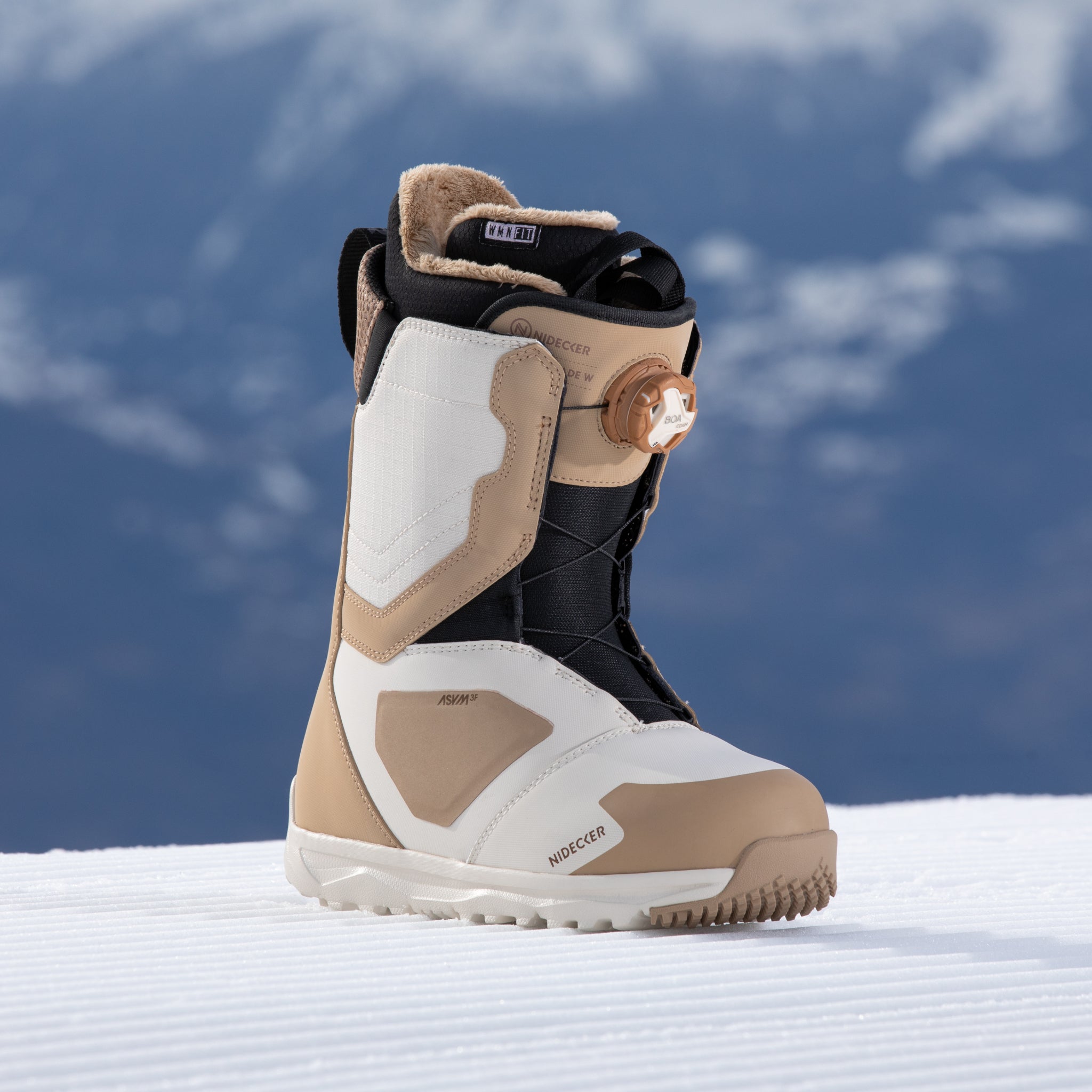 Nidecker Women's Cascade Snowboard Boot 2025 - A tan and white snowboard boot with a black strap on top, featuring a brown dial on the side.