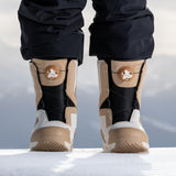 Nidecker Women's Cascade Snowboard Boot 2025 - A tan and black snowboard boot with a white logo on the side, standing in snow.