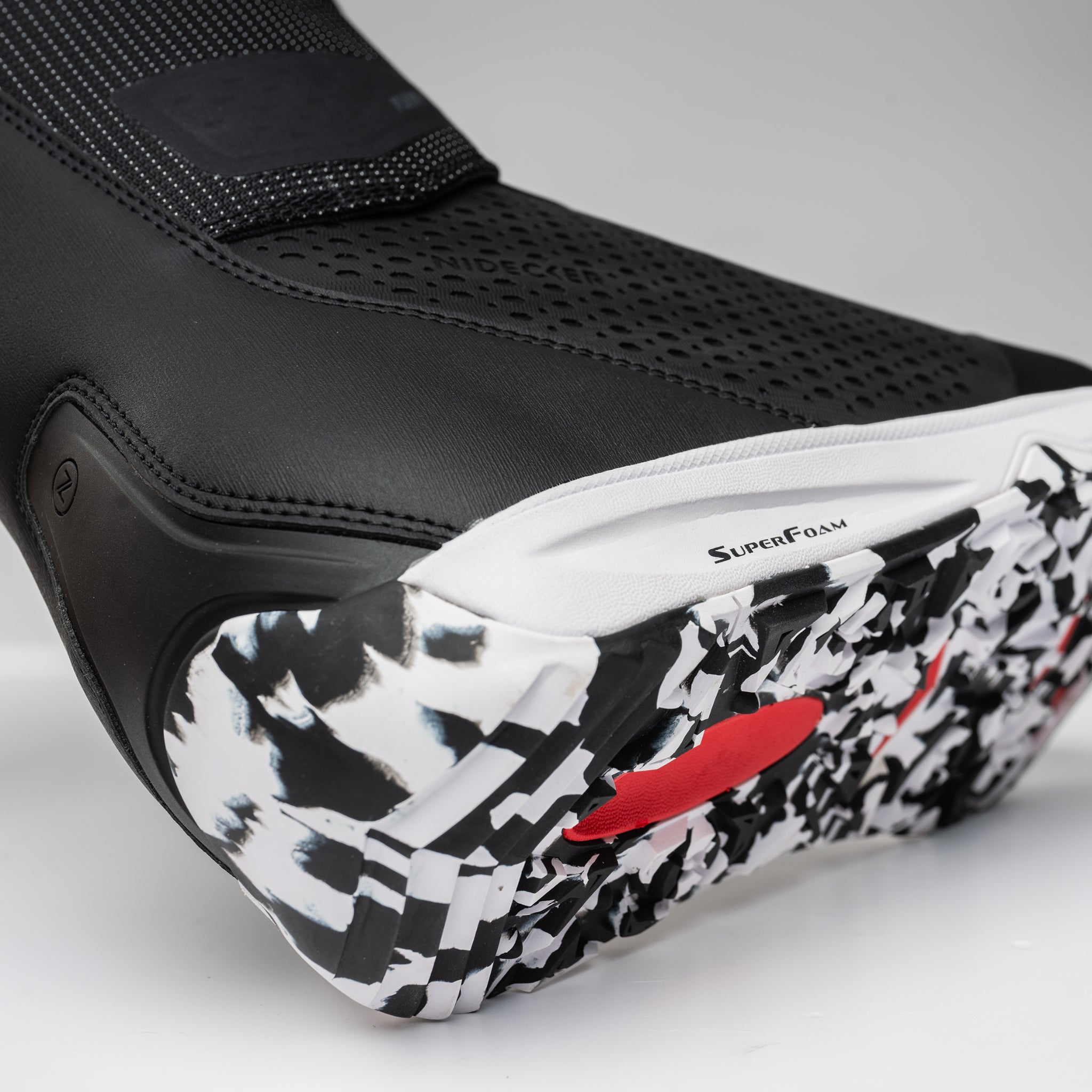 Nidecker Rift APX Men's Snowboard Boots 2025 - Black snowboard boots with a textured pattern on the toe and heel, featuring a white sole with black speckles.