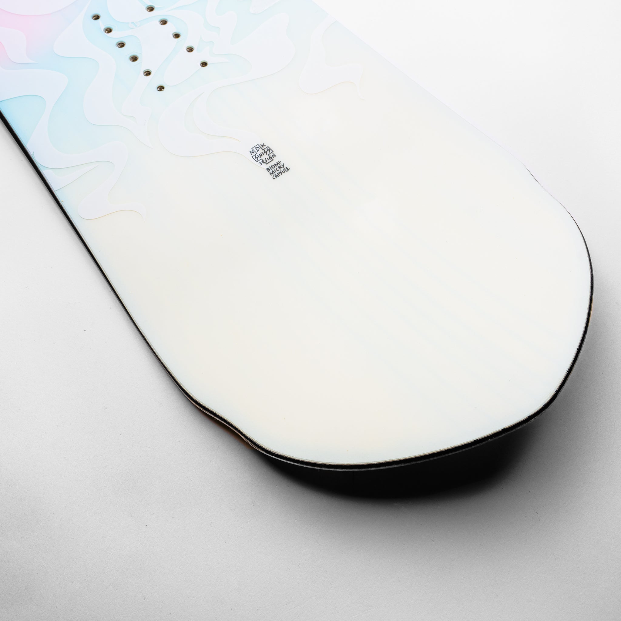 Nidecker Alpha Snowboard 2025 - A white snowboard with a blue and pink abstract design on top, featuring black hardware.