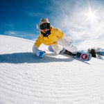 Nidecker Women's Astral Snowboard 2025 - A white snowboard with a red logo on its bottom edge, featuring a black strap and a blue design on top.