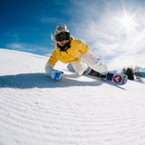 Nidecker Women's Astral Snowboard 2025 - A white snowboard with a red logo on its bottom edge, featuring a black strap and a blue design on top.