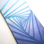 Nidecker Women's Astral Snowboard 2025 - A snowboard with a blue and white graphic design featuring geometric shapes and lines.