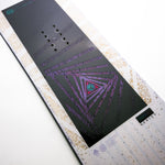 Nidecker Women's Astral Snowboard 2025 - A black snowboard with a purple and pink geometric pattern on its bottom.