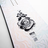Nidecker Beta Snowboard 2025 - A white snowboard with a black graphic of a swirling vortex in the center, featuring a fish and abstract shapes.