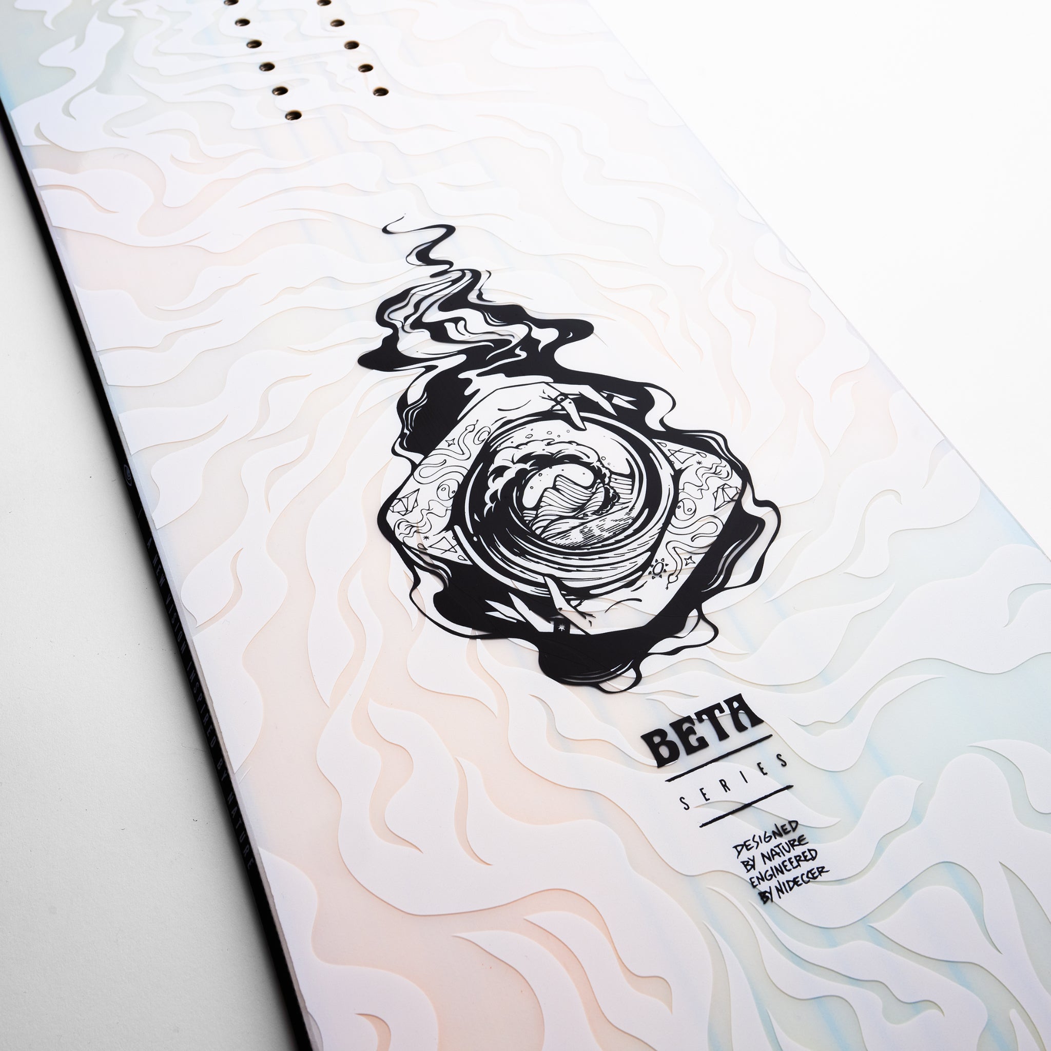 Nidecker Beta Snowboard 2025 - A white snowboard with a black graphic of a swirling vortex in the center, featuring a fish and abstract shapes.
