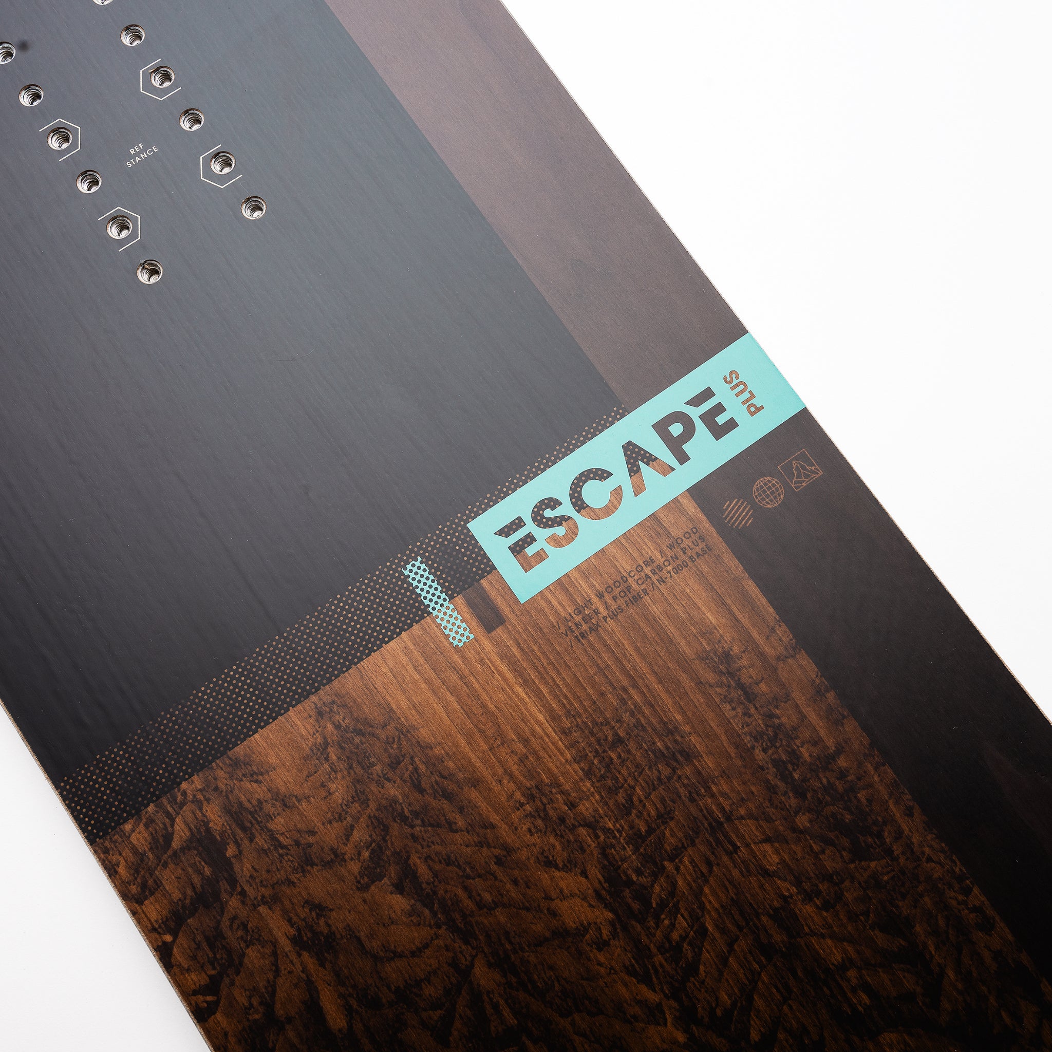 Nidecker Escape Plus Snowboard 2025 - A black snowboard with a white logo and text on top of a brown wooden background.