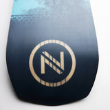 Nidecker Escape Plus Snowboard 2025 - A black snowboard with a white logo featuring an "N" and diagonal line, set against a light blue background.