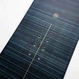 Nidecker Play Snowboard 2025 - A dark blue snowboard with a subtle wood grain pattern and silver screws.