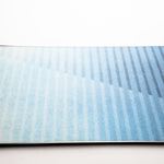Nidecker Play Snowboard 2025 - A light blue snowboard with a subtle white pattern on its surface.