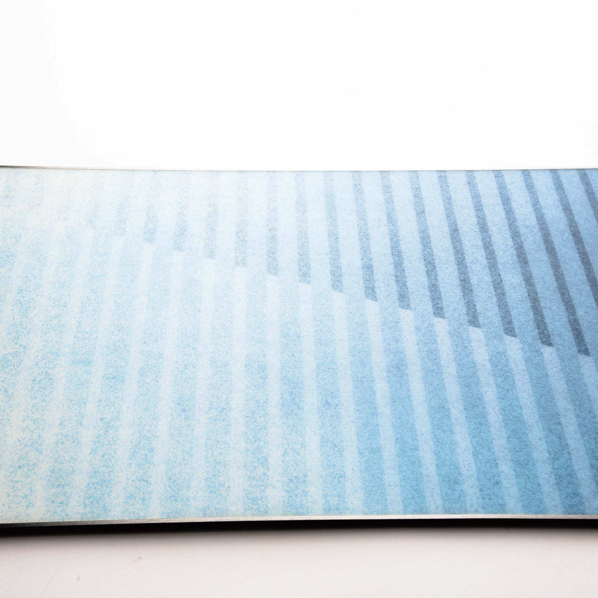 Nidecker Play Snowboard 2025 - A light blue snowboard with a subtle white pattern on its surface.