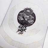 Nidecker Sensor Pro Snowboard 2025 - A black snowboard with a white logo and text on top of a wooden floor.