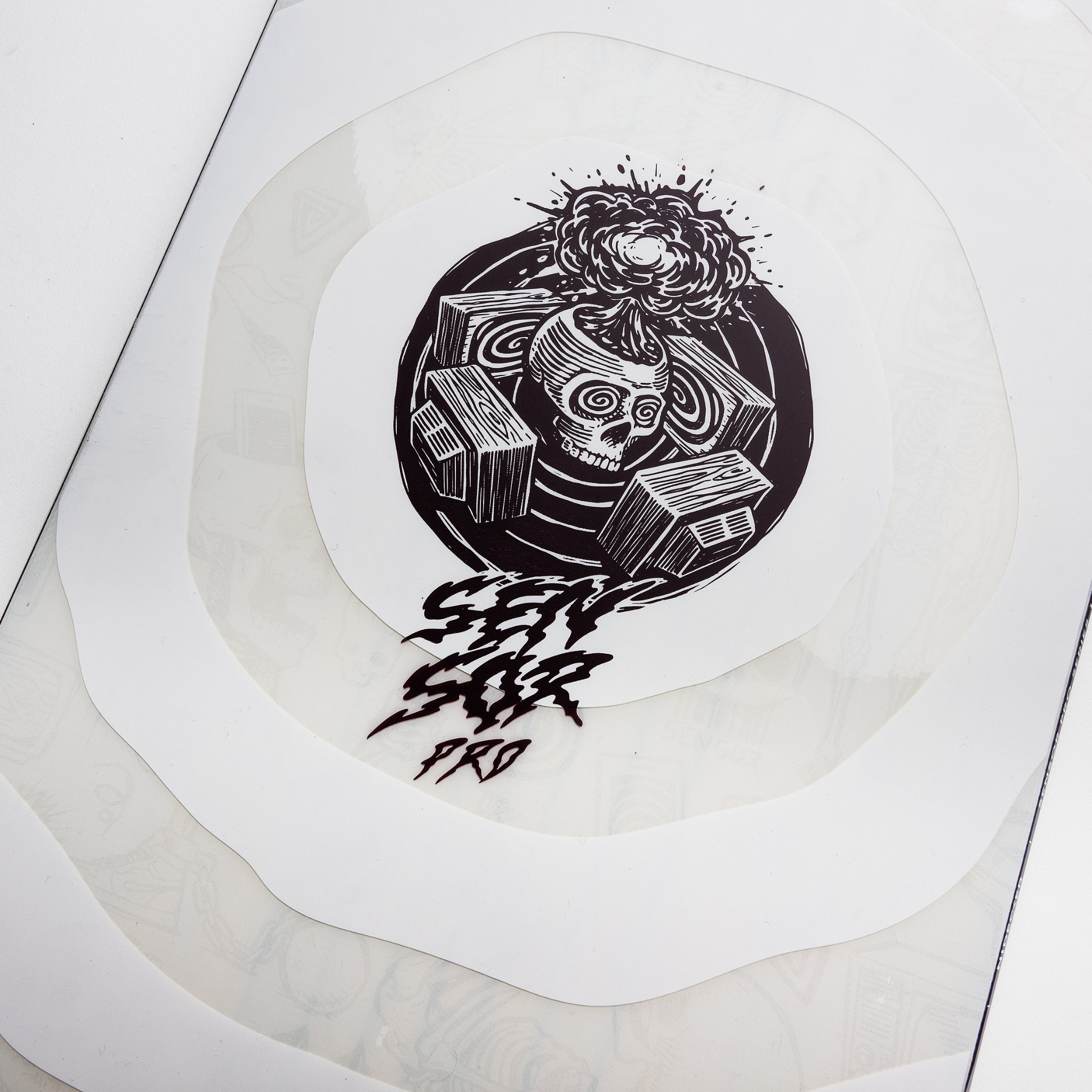 Nidecker Sensor Pro Snowboard 2025 - A black snowboard with a white logo and text on top of a wooden floor.